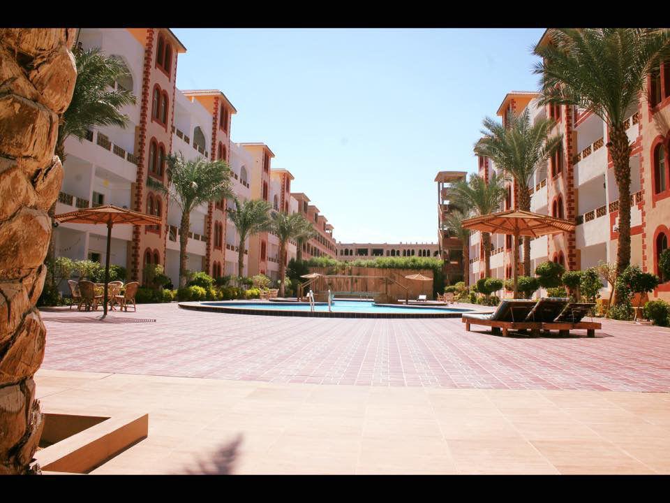 Viva Reef compound courtyard with palm trees and central pool